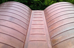 Curved barrel-vaulted copper roofs for barn