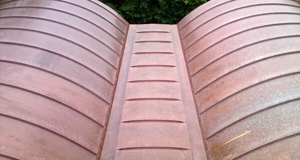 Curved barrel-vaulted copper roofs for barn